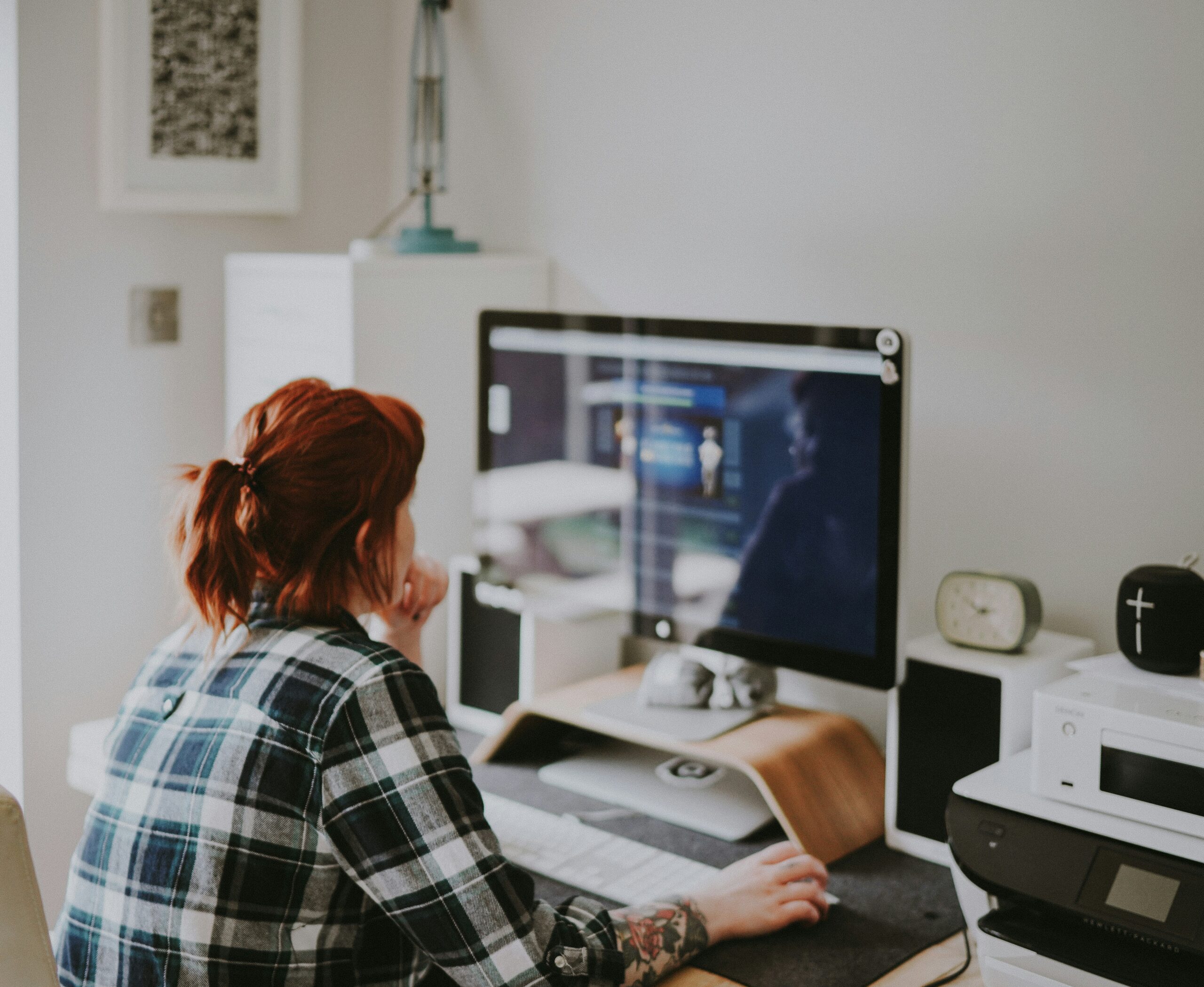 A person works on a computer in a home office.
